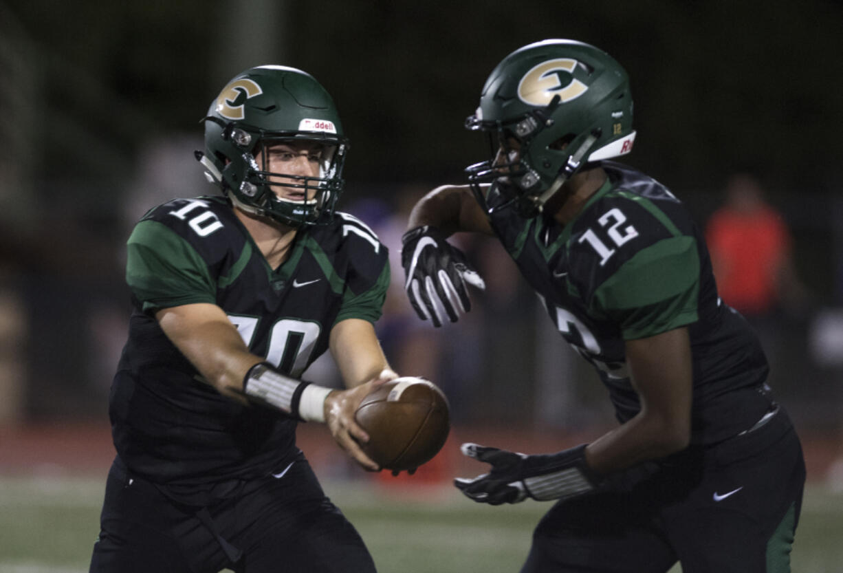 Evergreen’s Triston Fich (10) hands off to Zyell Griffin (12) during Friday night’s game against Columbia River at McKenzie Stadium on Sept. 1, 2017.