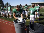 Mountain View's Michael Thanem dips his helmet in ice water during game vs. Ferris  on Saturday afternoon at McKenzie Stadium.