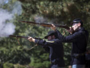 Park rangers Brett Roth, left, and Tyler Gordon demonstrate how historical weapons were used on the Fort Vancouver Parade Ground on Saturday. The demonstrations will return during the Campfires & Candlelight event happening Sept. 9.