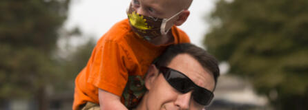 Declan Reagan, 5, sits atop the shoulders of his father, Francis Reagan, Tuesday outside the Washougal Police Department, where his dad serves as a police officer. Declan received a bone marrow transplant in July after being diagnosed with two types of cancer. “A woman in another country gave him the chance to have a life, and that’s really cool” says his mother, Lauren Reagan.