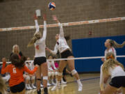 Ridgefield’s Anika Nicoll (4) goes up to block a hit from Camas’ Whitney Quist (8) during Tuesday’s volleyball season opener at Ridgefield High School. Camas won 3-1.