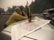 Jim Shank, left, and Colin Robertson of Washington State Department of Natural Resources join efforts to help fight the fire in Skamania on Tuesday afternoon.