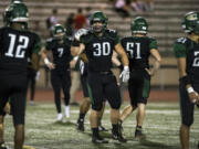 Evergreen’s Serge Rusnak (30) calls out to teammates before lining up for the snap during the game against Columbia River at Makenzie Stadium on Sept. 1, 2017.