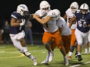 Storm Angelo Sarchi (1) fends off Crusader Ryan Taylor (77) during the Friday night football ball game at Kiggins Bowl between Skyview High School and Eastside Catholic School on Sept. 8, 2017.