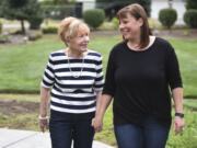 Marian Markley, 77, left, walks Thursday with her daughter Val Dewitz, 44, at Dewitz’s home in Ridgefield. Markley was adopted at birth, but with the help of Dewitz, they were able to locate and meet Markley’s biological sister last month in California.