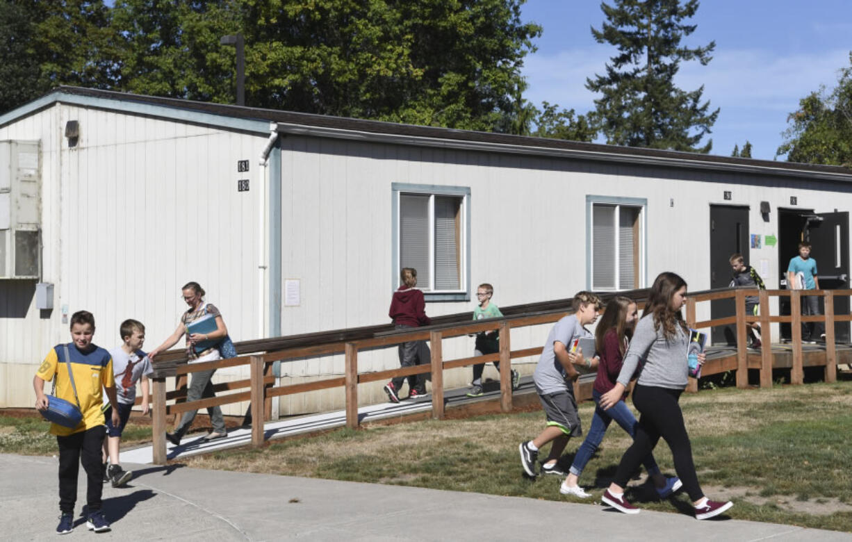 Sixth-grade students leave a portable at La Center Elementary School, where there are a total of 18 portable classrooms to help deal with the district’s growing population. The district will put a bond up for vote in February to build a new elementary or middle school to help deal with overcrowding.