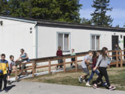 Sixth-grade students leave a portable at La Center Elementary School, where there are a total of 18 portable classrooms to help deal with the district’s growing population. The district will put a bond up for vote in February to build a new elementary or middle school to help deal with overcrowding.