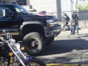 A photographer dives out of the way of a truck after a rally held by Joey Gibson's Patriot Prayer Group in Vancouver on Sunday. The event was moved to Vancouver from Portland in an attempt to avoid protesters.