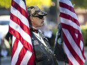 Vietnam veteran Donald Gagnon of Vancouver bears the American flag during the Patriot Day ceremony at Vancouver City Hall on MondayThe ceremony was held to remember the 9/11 terrorist attacks.