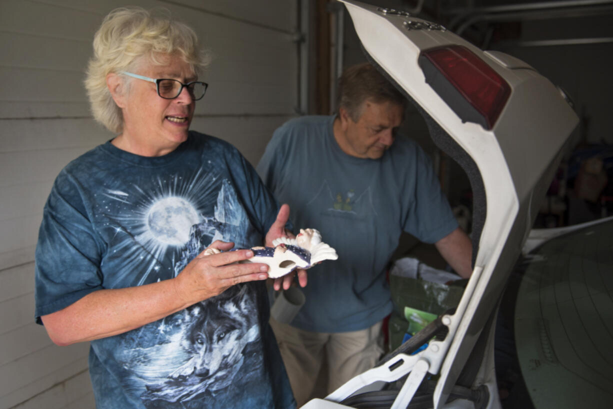 Kathy Kolstad shows the belongings she’s kept in her car in case she and her husband have to evacuate their home just west of Archer Mountain. After warnings from their granddaughter and a neighbor on Tuesday morning, Kathy and her husband had help from their granddaughter to packed up important belongings and evacuate.