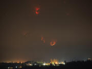 The Eagle Creek Fire continues to burn in the Columbia River Gorge behind Cascade Locks, Ore., as seen on Thursday night from Stevenson.