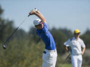 Graham Moody of Mountain View, left, tees off on the 12th hole as Keith Lobis of Union looks on during the Jeff Hudson Invitational High School Golf Tournament at Tri-Mountain Golf Course on Tuesday morning, Sept. 12, 2017.