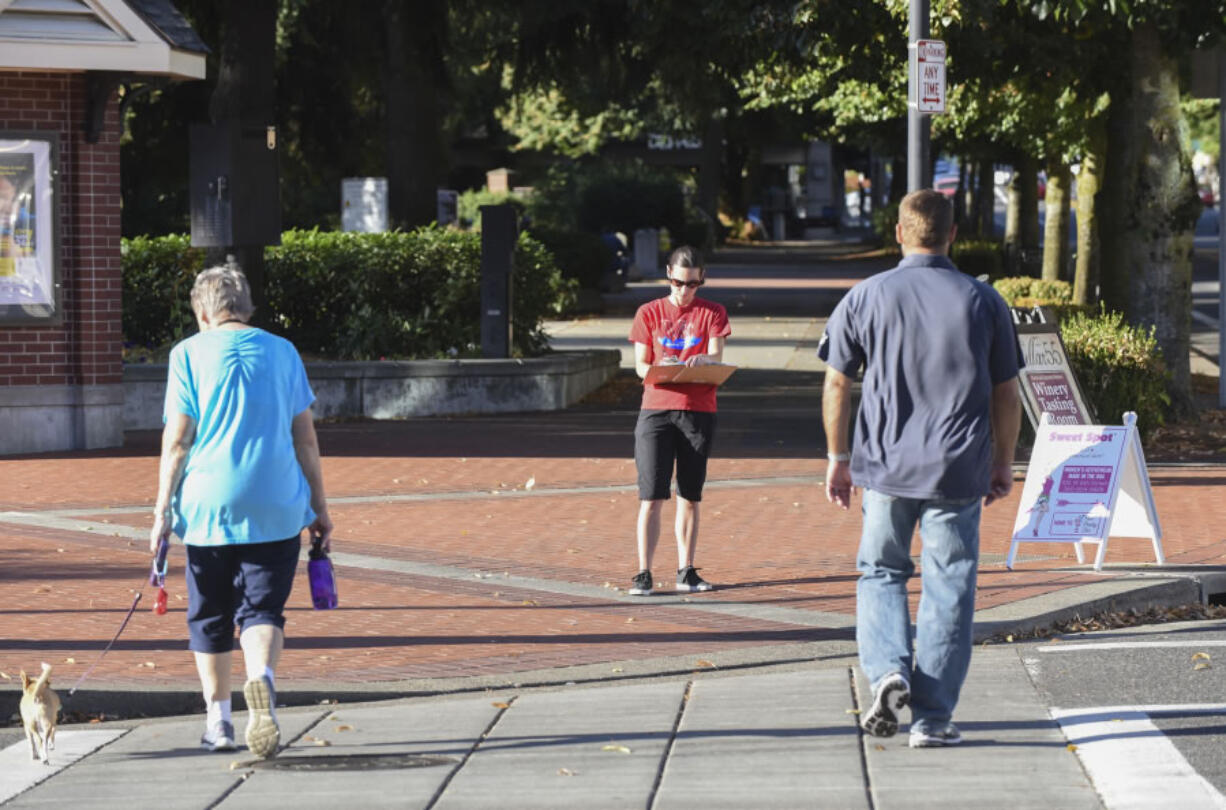 The intersection at West 6th and Columbia streets is particularly busy with pedestrians, skateboarders and bicyclists. Erin Kingsley, in red, volunteered to count them all during an afternoon last week in effort to get a sense of how pedestrian infrastructure is used.