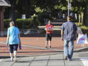 The intersection at West 6th and Columbia streets is particularly busy with pedestrians, skateboarders and bicyclists. Erin Kingsley, in red, volunteered to count them all during an afternoon last week in effort to get a sense of how pedestrian infrastructure is used.