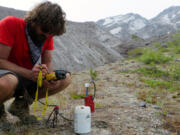 Steve Hanson from the University of New Mexico sits next to one of 140 seismometers placed on Mount St. Helens to examine very subtle activity below the surface. (U.S.