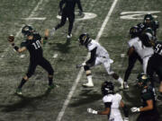 Evergreen quarterback Triston Fich looks for a deep receiver against Hudson's Bat at McKenzie Stadium on Friday, September 15, 2017.