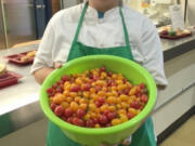 Fircrest: Fircrest Elementary School food service employee Stephanie Hilbert preparing the cherry tomato tasting at the school as part of the Washington State University Extension’s Supplemental Nutrition Assistance Program Education’s Harvest of the Month.