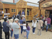 Long lines of visitors wait to tour the different tiny houses at the Tiny House Living Festival at the Clark County Event Center at the Fairgrounds on Saturday. The festival, bringing 17 tiny houses on wheels, eight converted school buses and other minimalist living options, ends Sunday.