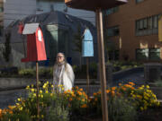 Marg Nelson of Vancouver, a spiritual health volunteer, admires the colorful birdhouses in the newly renovated healing garden Friday morning at Legacy Salmon Creek Medical Center. Nelson sponsored the creation of a labyrinth in the garden, which will be officially unveiled to the community at an event at 3:30 p.m. Wednesday.