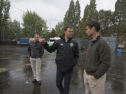 Greg McGreevey of Pacific FC, from left, joins Jack Jewsbury of the Portland Timbers and Bart Hansen of the Vancouver City Council as they tour a possible site Monday afternoon for a new futsal court near the Fort Vancouver Regional Library district headquarters.