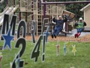 DeWayne Ledbetter of Portland and Lee Rafferty of Vancouver swing at Esther Short Park in downtown Vancouver with the Parks Foundation's "Swing More 24" event created in conjunction with the fourth annual ÒGive More 24!Ó on Thursday afternoon, Sept. 21, 2017.