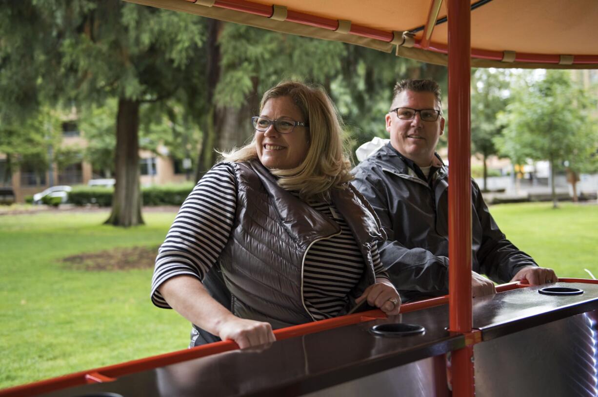 Julie Williams, left, and Mike Kretzschmar, both of Vancouver ride along in the Couve Cycle for the fourth annual ÒGive More 24!Ó on Thursday afternoon, Sept. 21, 2017.  The Watershed Alliance of Southwest Washington teamed up with Couve Cycle to give tours of the park and the waterfront development, educating riders on how their organization is keeping local waterways clean.