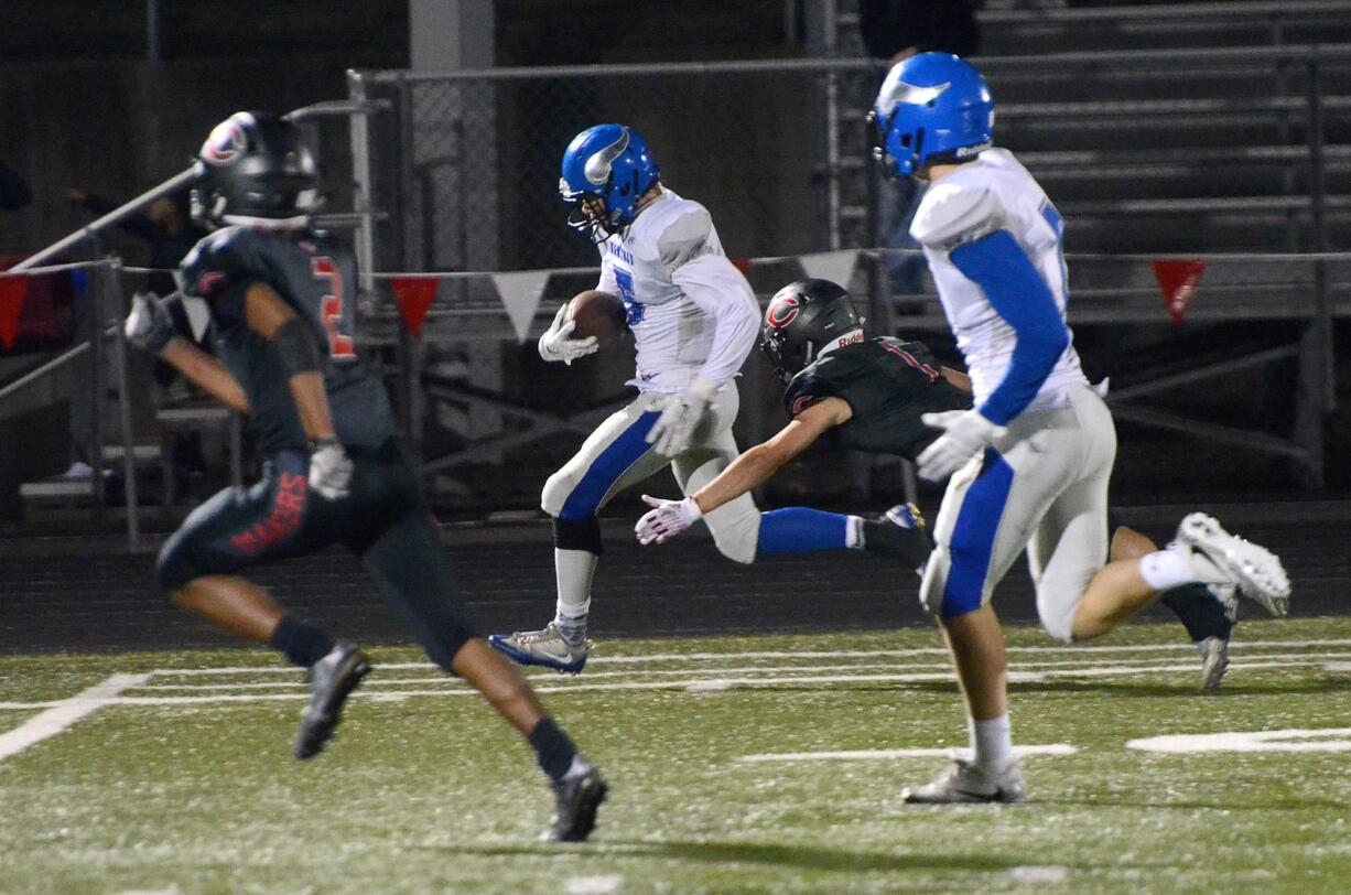 Camas defender Trevor Bentley barely catches Coeur d'Alene receiver Brett Hunter at Doc Harris Stadium in Camas on Friday, September 22, 2017. Camas beat Coeur d'Alene 28-25.