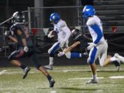 Camas defender Trevor Bentley barely catches Coeur d'Alene receiver Brett Hunter at Doc Harris Stadium in Camas on Friday, September 22, 2017. Camas beat Coeur d'Alene 28-25.