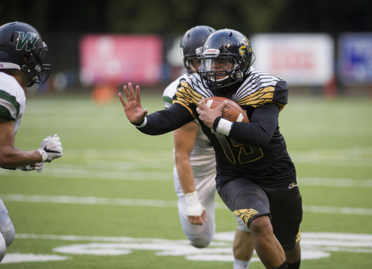 Hudson's Bay's Akilotoa Kaumatule (15) escapes Woodland players during the second quarter against Woodland at Kiggins Bowl in Vancouver, Friday Sept. 22, 2017.