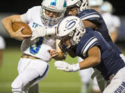 Mountain View’s Glen Perry Jr. (3) is hit by Skyview’s Jayden Chatman (88) and Angelo Sarchi (1). Perry left the game in the second quarter with a knee and ankle injury.