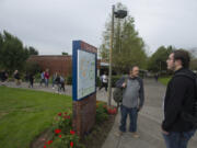 Clark College student Chad Hatch, in gray, of Battle Ground and Aidan Brinkman, a Running Start student from Hockinson, pause to get directions while finding their way around campus during the first day of classes late Monday morning. About 12,000 students are enrolled at the college this quarter.