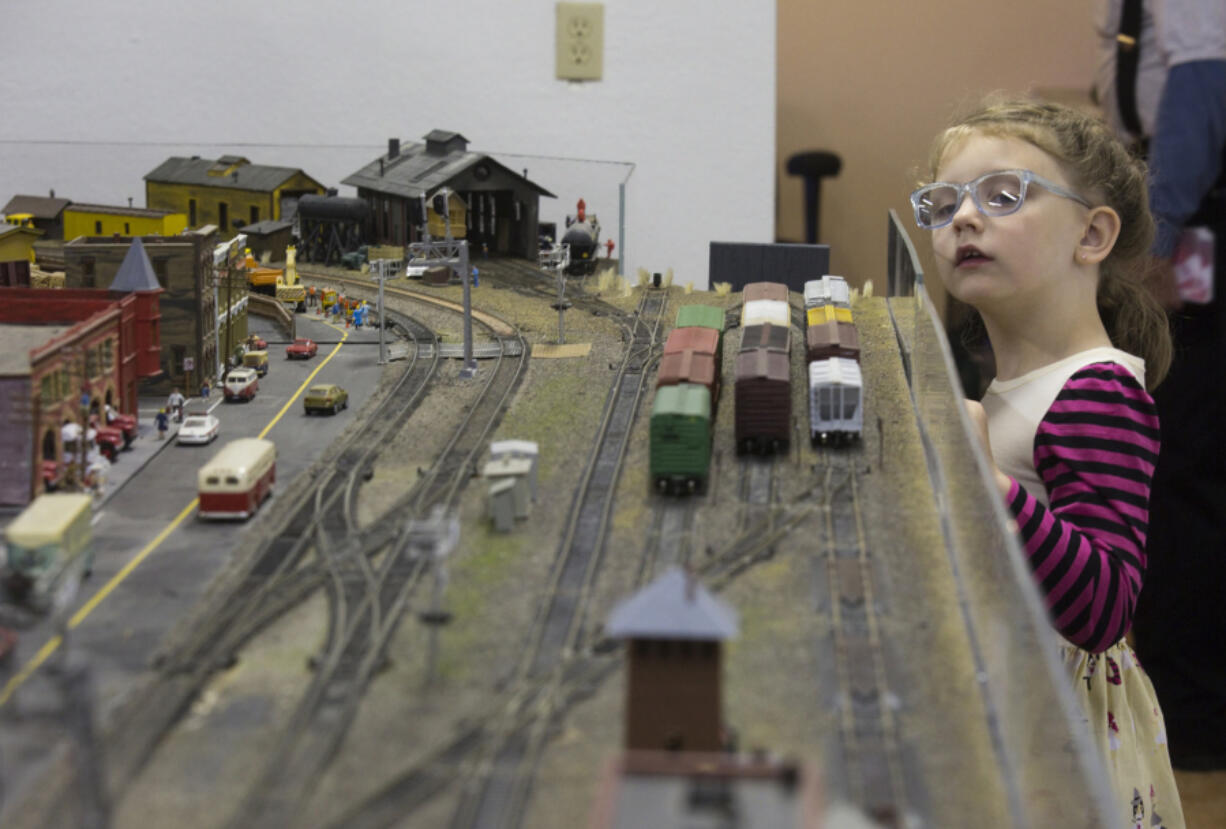 The model landscape, above, at the Southwest Washington Model Railroaders is almost at eye level with Carma Keller, 5, who turned out for the club’s annual open house.