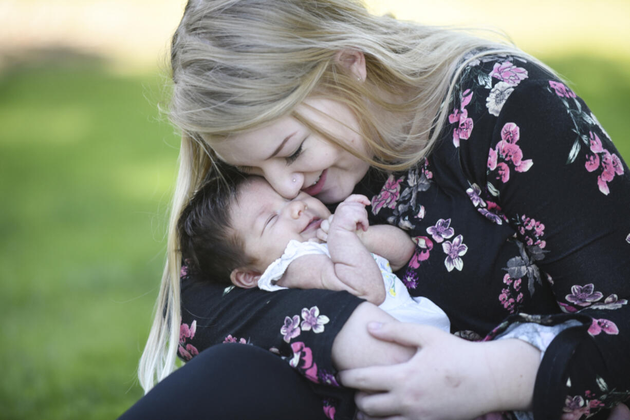 Zoe Davisson, 18, snuggles with her daughter, 7-week-old Rae Davisson, during a visit Thursday to H.B. Fuller Park in Vancouver. Davisson enrolled in the county’s Nurse-Family Partnership program while pregnant. PeaceHealth Southwest Medical Center is working with the county to help sustain and expand the program for young, first-time moms.