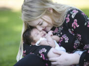 Zoe Davisson, 18, snuggles with her daughter, 7-week-old Rae Davisson, during a visit Thursday to H.B. Fuller Park in Vancouver. Davisson enrolled in the county’s Nurse-Family Partnership program while pregnant. PeaceHealth Southwest Medical Center is working with the county to help sustain and expand the program for young, first-time moms.