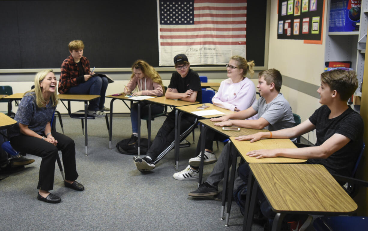 Social studies teacher Stephanie Etulain, left, laughs with sophomore Brock Davidson on Thursday while he recounts his experience in her Tiger Core directed studies class as a freshman with other Tiger Core students at Battle Ground High School. Most Tiger Core students continued into Etulain’s sophomore-level world studies class, helping maintain the emotional support the program is designed to provide struggling students.