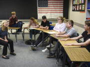 Social studies teacher Stephanie Etulain, left, laughs with sophomore Brock Davidson on Thursday while he recounts his experience in her Tiger Core directed studies class as a freshman with other Tiger Core students at Battle Ground High School. Most Tiger Core students continued into Etulain’s sophomore-level world studies class, helping maintain the emotional support the program is designed to provide struggling students.