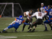 Washougal #5 Kade Coons runs with the ball as Ridgefield High School's Jeremy Martin, #35 tries to tackle him at a game Friday September 29, 2016. Washougal squared off with Ridgefield.