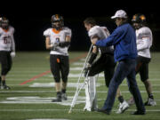 Washougal’s Brevan Bea heads off the field on crutches after suffering fractures to his left tibia and fibula during the Panthers’ win over Ridgefifeld on Friday.