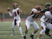 Prairie's Jayson Maddux (18) looks for an open teammate in the first quarter at McKenzie Stadium on Friday afternoon, Sept. 29, 2017.