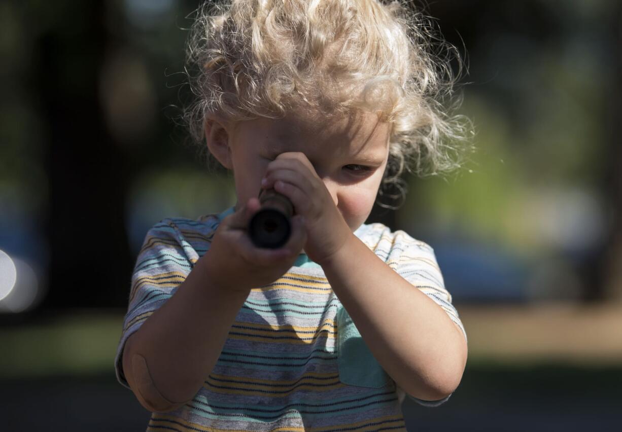 Calien Ranalli, 2, plays with a toy telescope at Marshall Park in Vancouver on Wednesday afternoon.