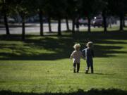 Emilee Shepersky, 2, left, and Makayla Gale, 4, both of Vancouver, run through the grass together at Marshall Park in Vancouver on Wednesday afternoon. Emilee's mother, Michelle Jensen, said she decided to come out to the park to enjoy the nice weather and burn off some energy.