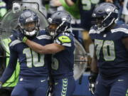 Seattle Seahawks wide receiver Paul Richardson, left, is greeted by teammates Tyler Lockett, center, and Rees Odhiambo (70) after Richardson caught a pass for a touchdown against the San Francisco 49ers in the second half of an NFL football game Sunday, Sept. 17, 2017, in Seattle.