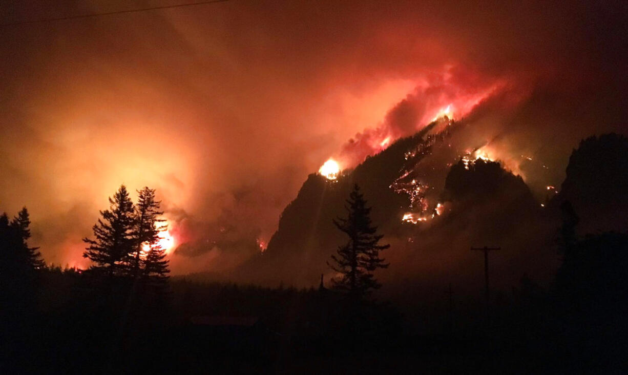 This Sept. 4, 2017, photo provided by Inciweb shows the Eagle Creek wildfire burning in the Columbia River Gorge east of Portland, Ore. A lengthy stretch of highway Interstate 84 remains closed Tuesday, Sept. 5, 2017, as crews battle the growing Eagle Creek wildfire that has also caused evacuations and sparked blazes across the Columbia River in Washington state.