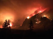 This Sept. 4, 2017, photo provided by Inciweb shows the Eagle Creek wildfire burning in the Columbia River Gorge east of Portland, Ore. A lengthy stretch of highway Interstate 84 remains closed Tuesday, Sept. 5, 2017, as crews battle the growing Eagle Creek wildfire that has also caused evacuations and sparked blazes across the Columbia River in Washington state.