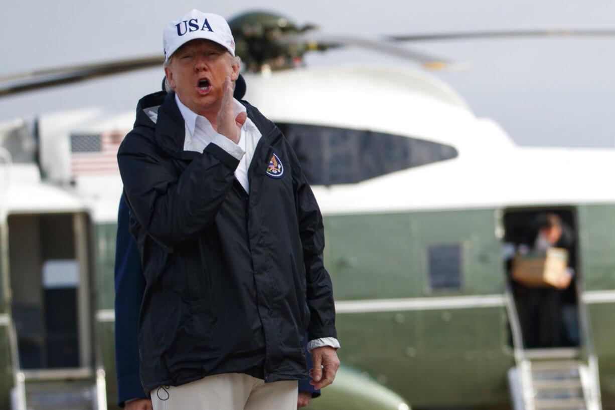 President Donald Trump responds to a reporters question as he boards Air Force One with first lady Melania Trump, not shown, for a trip to Florida to meet with first responders and people impacted by Hurricane Irma, Thursday, Sept. 14, 2017, in Andrews Air Force Base, Md.