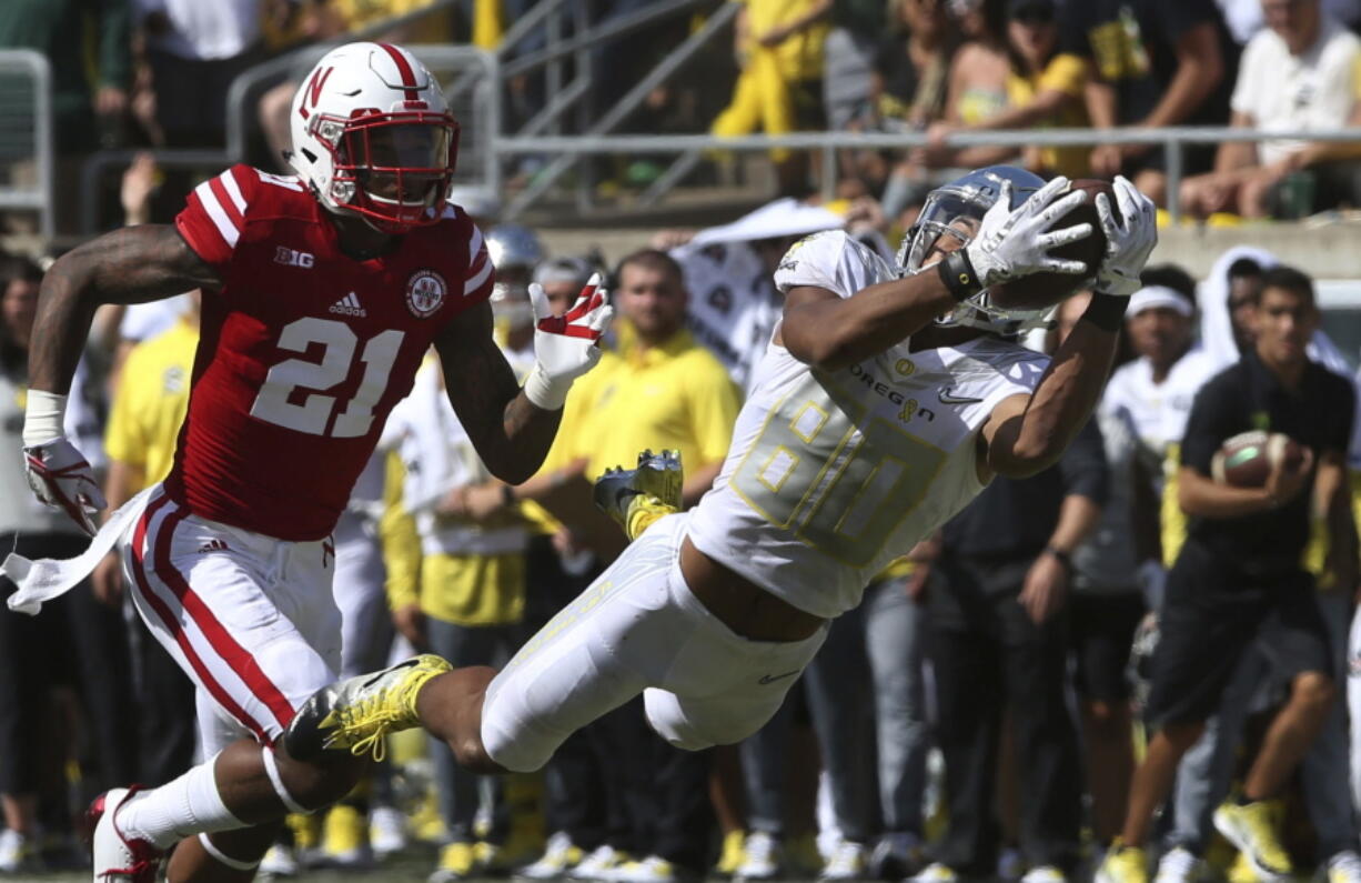 Oregon wide receiver Johnny Johnson III, right, pulls down a diving catch ahead of Nebraska of defensive back Lamar Jackson during the second quarter of an NCAA college football game Saturday, Sept. 9, 2017, in Eugene, Ore.