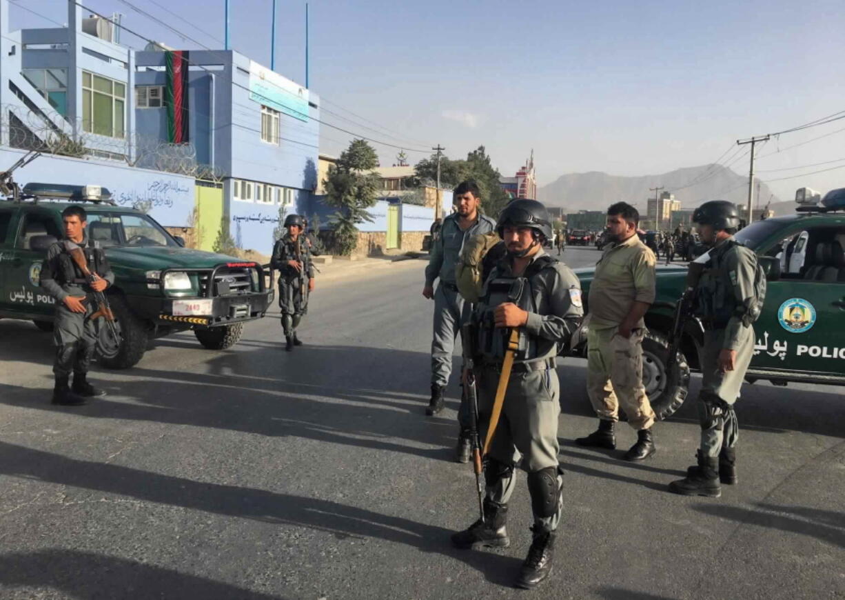 Afghan security police stand guard near the site of a deadly suicide attack outside a cricket stadium, in Kabul, Afghanistan, on Wednesday.