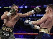 Gennady Golovkin, left, fights Canelo Alvarez during a middleweight title fight Saturday, Sept. 16, 2017, in Las Vegas.