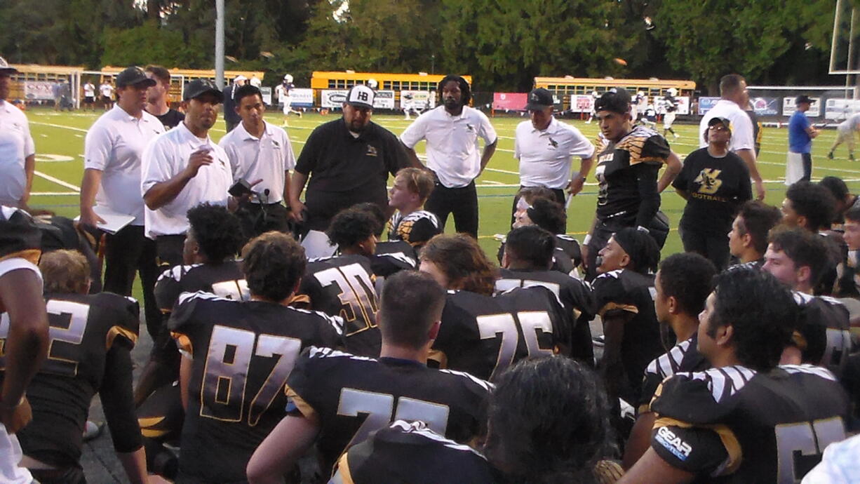 Hudson's Bay coach Ray Lions talks to his players after their 31-28 win over La Salle of Milwaukie, Ore.