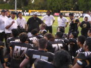 Hudson's Bay coach Ray Lions talks to his players after their 31-28 win over La Salle of Milwaukie, Ore.